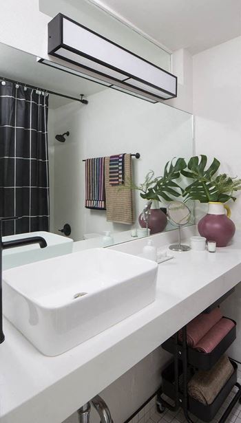 A white bathroom with a sink and a mirror